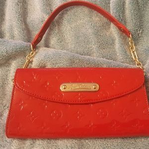 Red patent leather clutch.